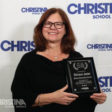Photo of Shivaun Jester McVey ES Teacher of the Year holding plaque